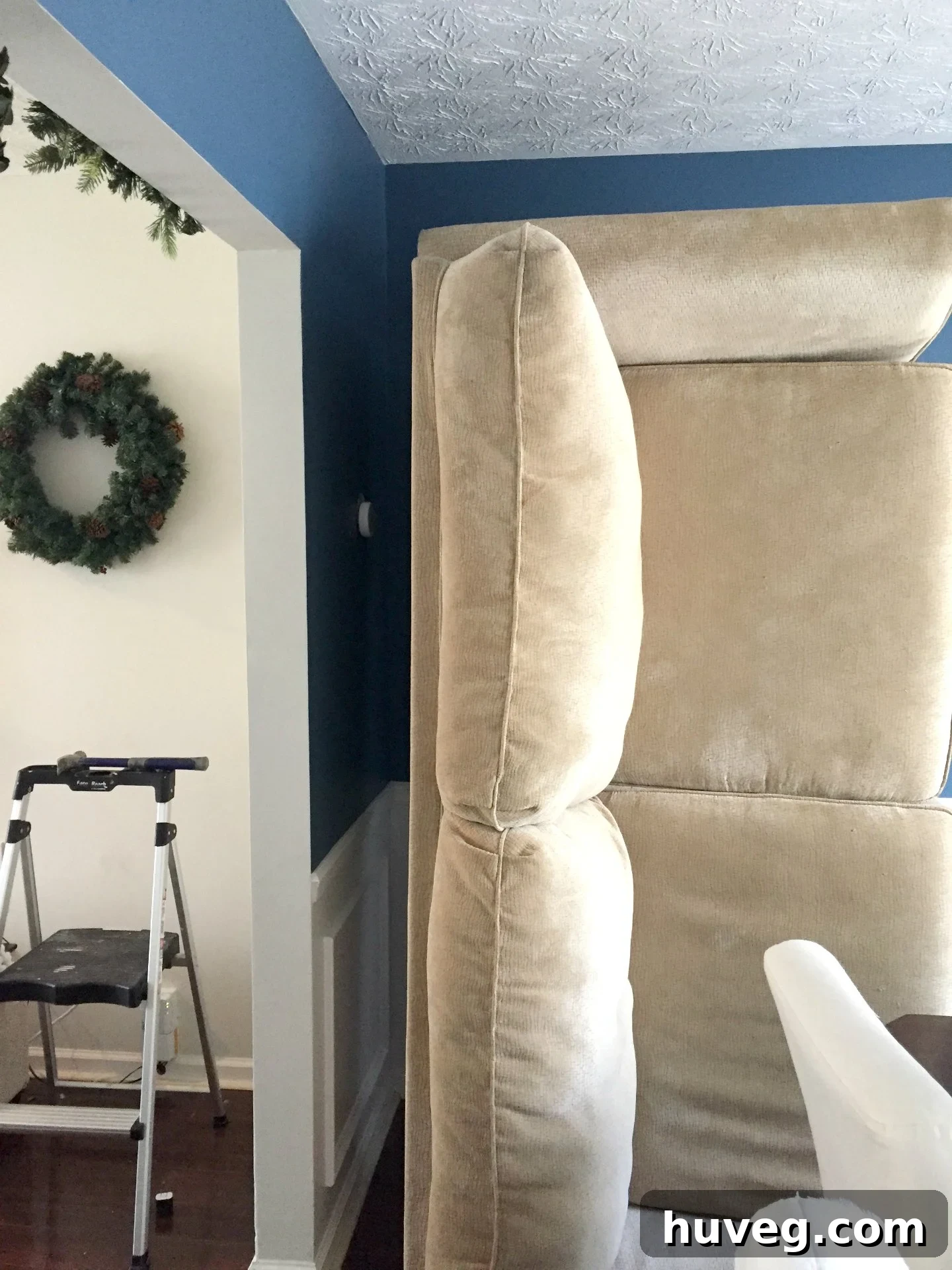 Couch placed sideways in the dining room corner during renovation, prior to Christmas decor