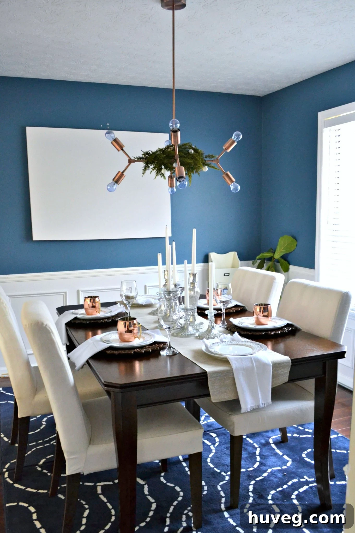 Elegantly decorated dining room for Christmas with neutral tones and metallic accents