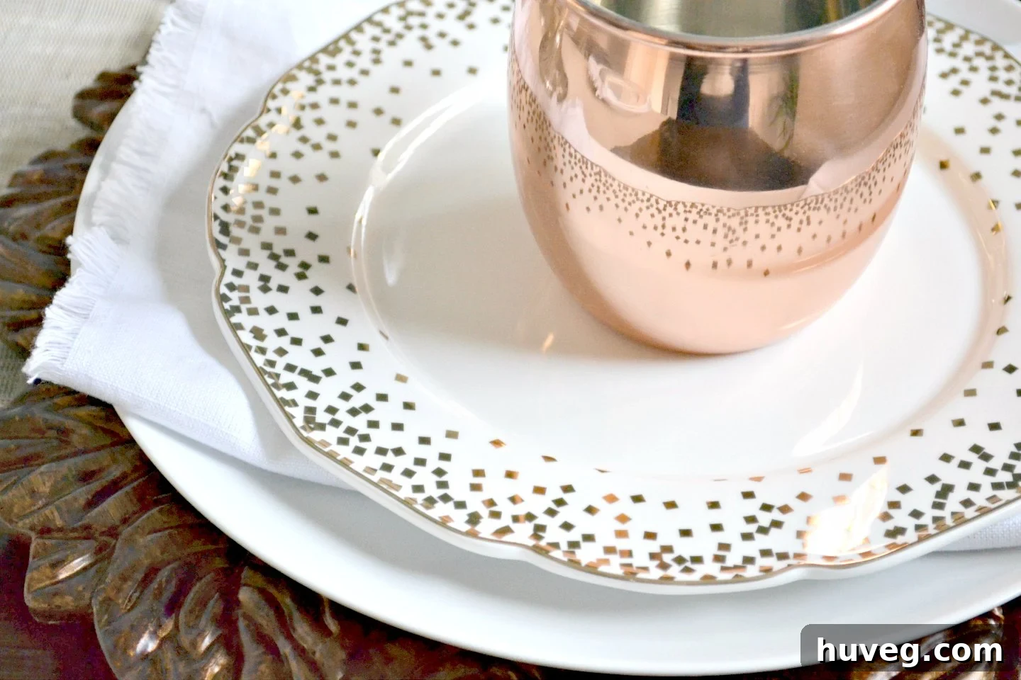 Close-up of Nicole Miller confetti plates for Christmas dining
