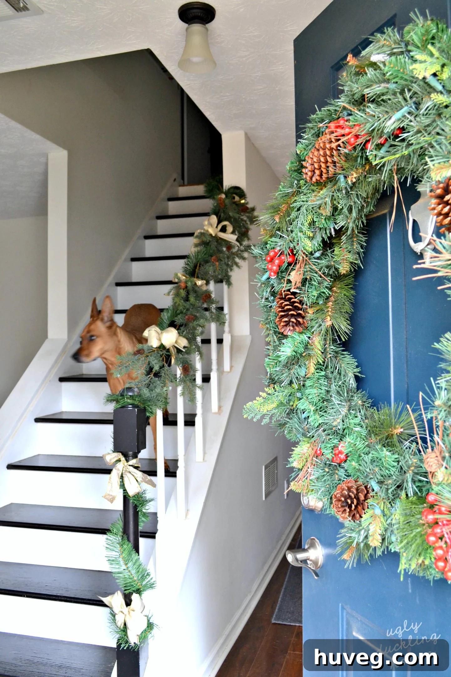 Christmas front door adorned with elegant neutral decor, showcasing gold, silver, and white elements for a winter wonderland theme.