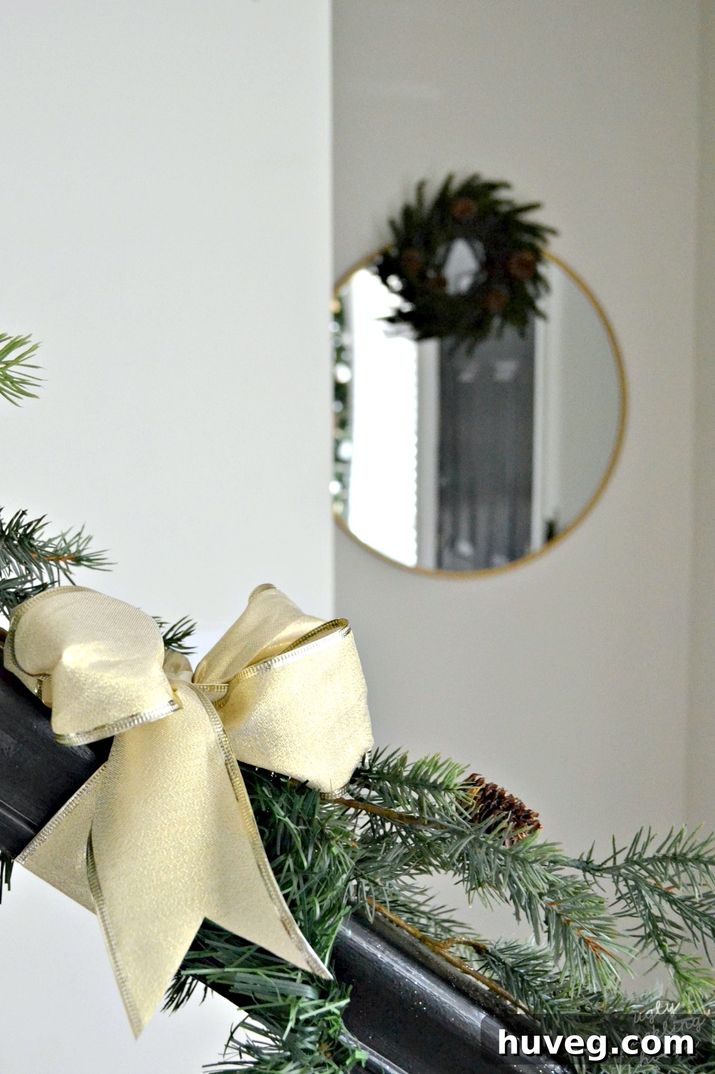 Simple and elegant neutral Christmas entryway featuring a stylish hall mirror, decorated with subtle holiday touches for a welcoming atmosphere.