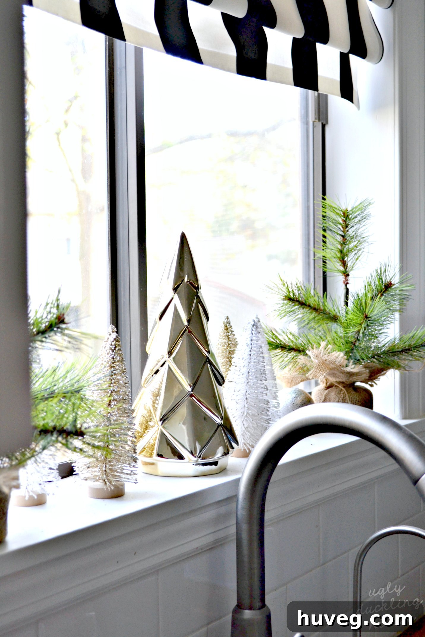 Don't forget to decorate the kitchen window for Christmas with a beautiful gold and white neutral theme, enhancing holiday cheer.