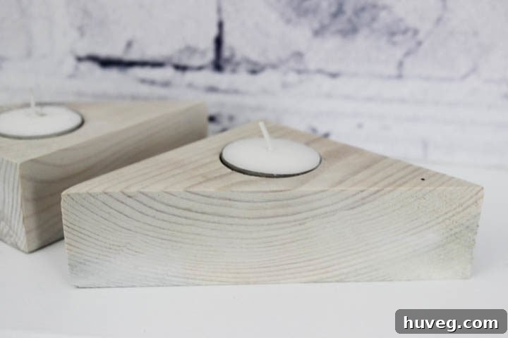 An inviting arrangement of diverse triangle tea light holders with flickering candles, creating a cozy and welcoming atmosphere.