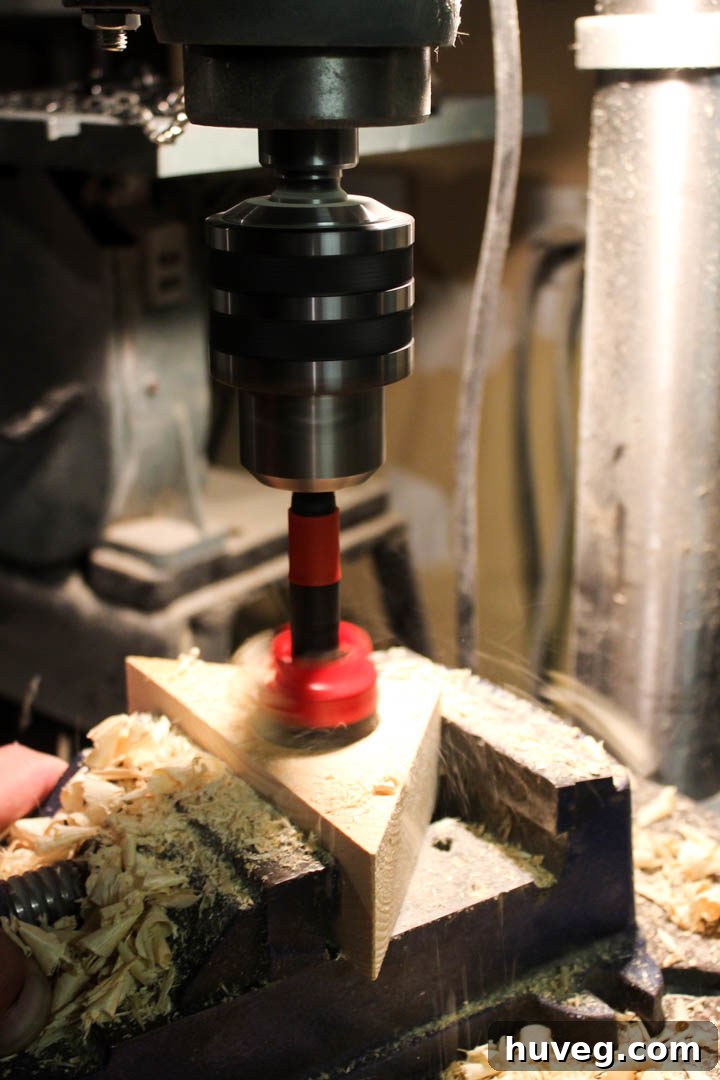 Utilizing a 1 1/2-inch Forstner bit to precisely drill the flat-bottomed cavity for a tea light candle in the wooden holder.