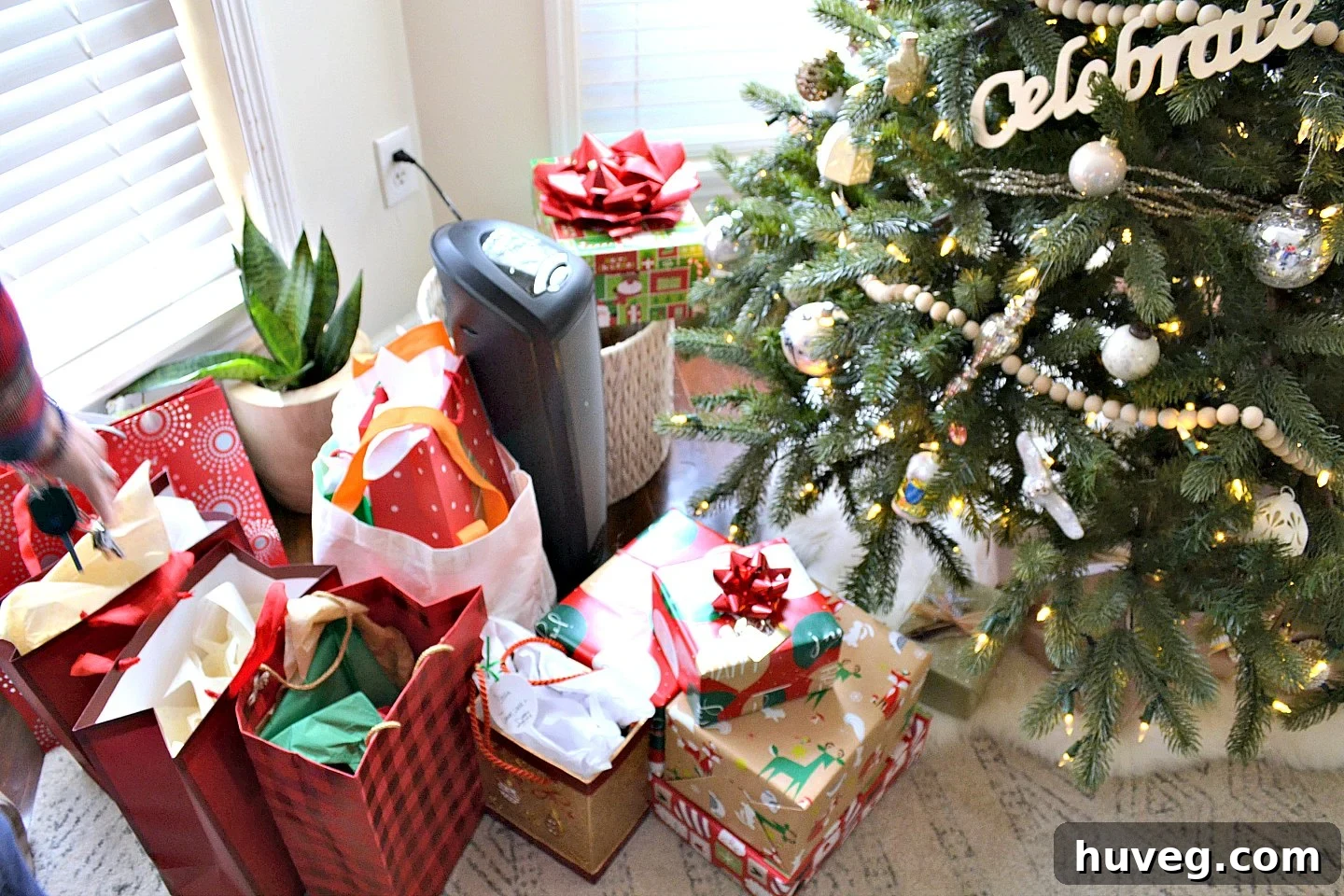Presents in a pile under the Christmas tree, beautifully wrapped and awaiting distribution.