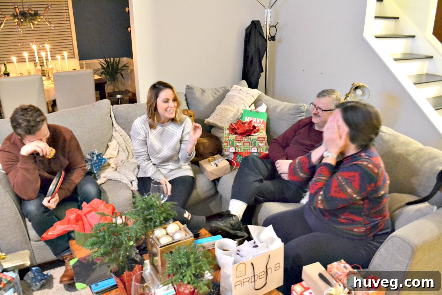 Family members caught in a candid moment, laughing and enjoying each other's company during the Christmas gathering.