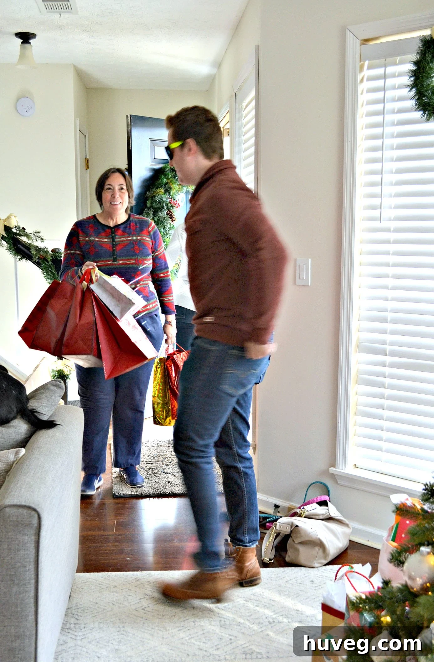 Family members arriving at the house, bringing presents and cheer into the home during Christmas.