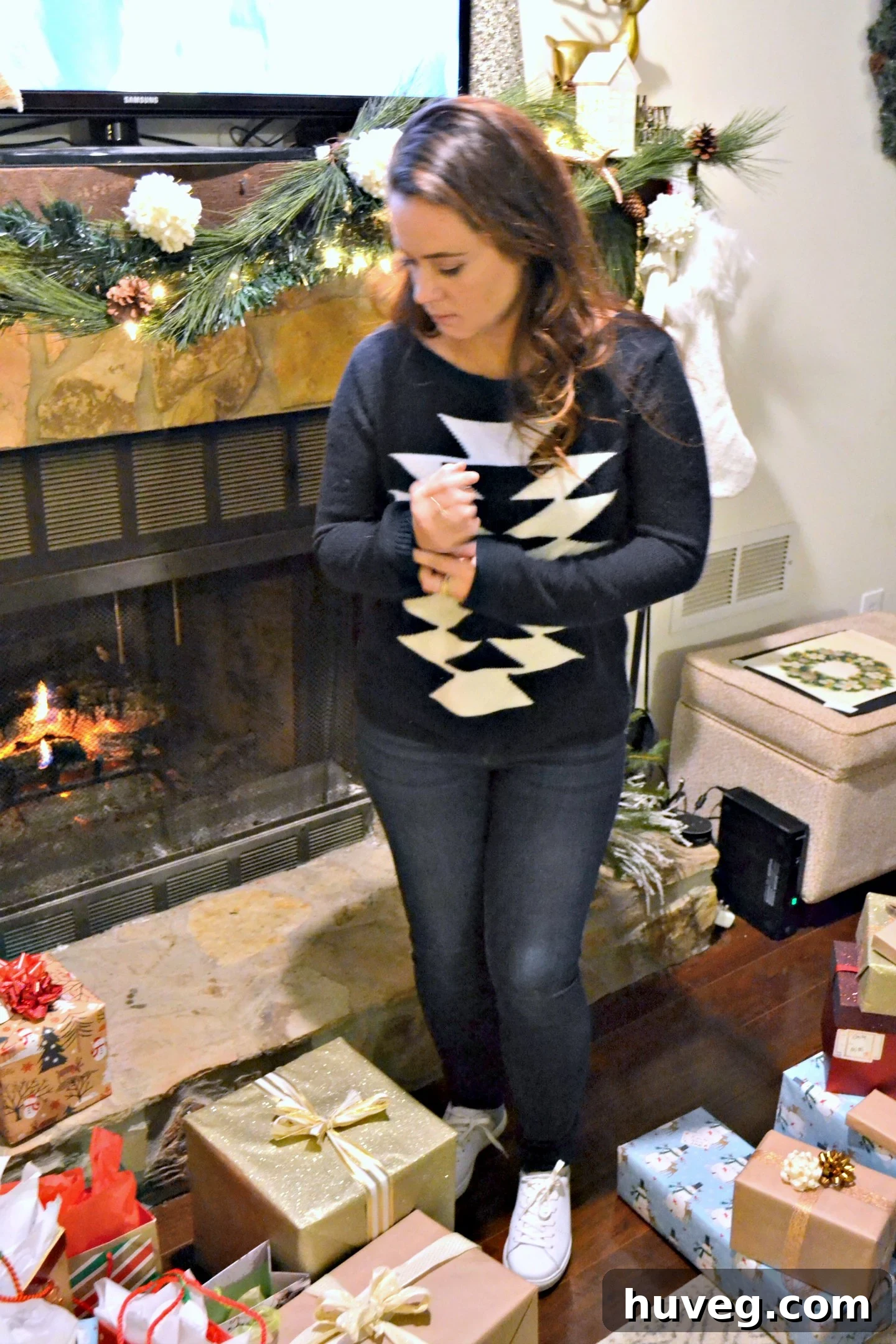 The host, surrounded by gifts, diligently sorting and organizing presents for distribution, a common pre-gift-opening scene.