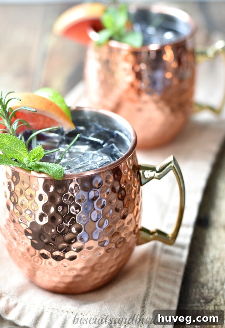 A top-down view of the grapefruit Moscow Mules with garnishes.