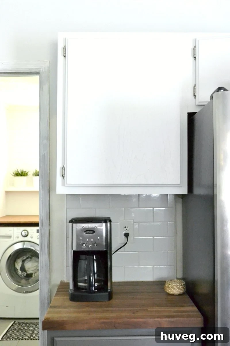 Kitchen with coffee maker on right side, showcasing a neat countertop