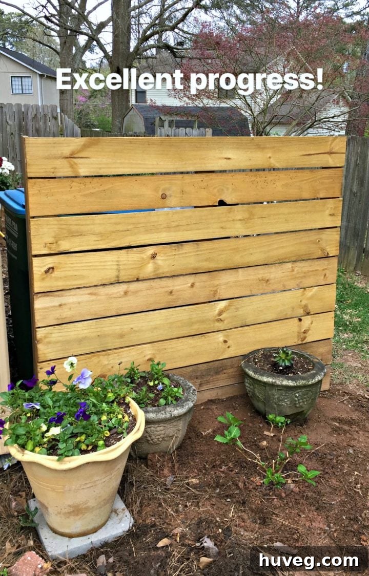 Front of wood screen next to garage, showcasing a completed outdoor privacy project and improved curb appeal