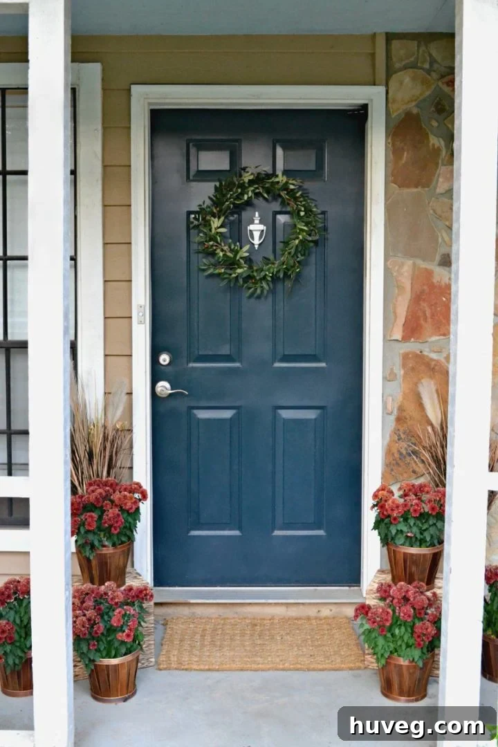 blue front door with red mums - fall house tour