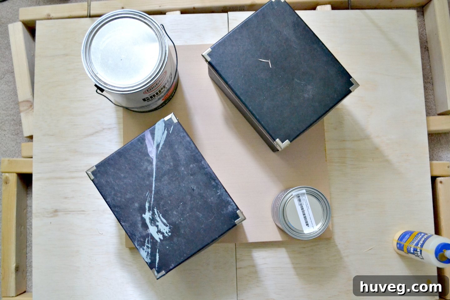 To ensure a strong bond, I used paint cans and various heavy household items to weigh down the reclaimed wood frame as the glue dried, ensuring its stability.