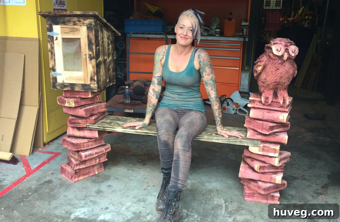 Finished cedar bench intricately carved with books and an owl by Griffon Ramsey