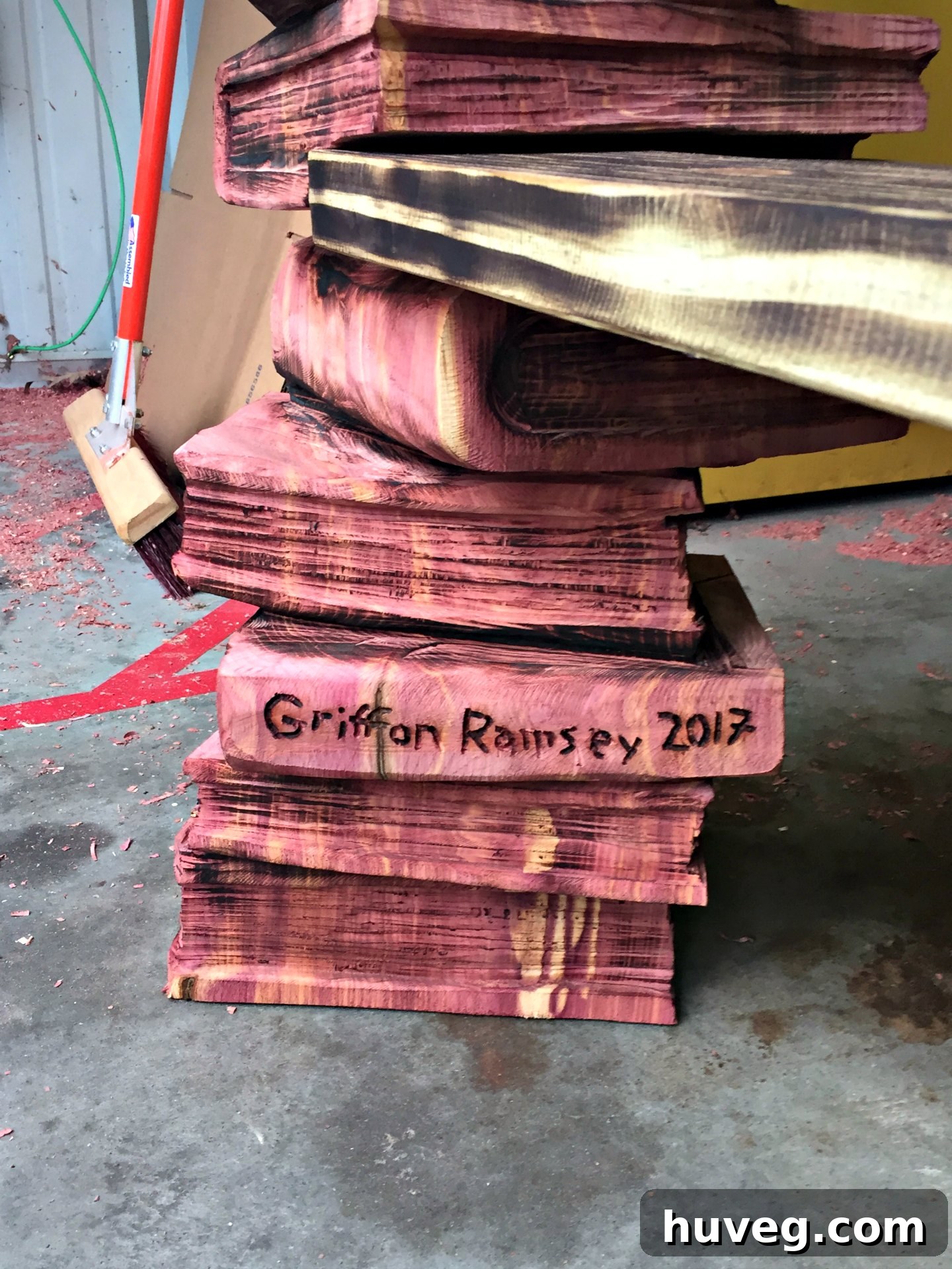 Detail of a wood carving by Griffon Ramsey depicting a stack of books