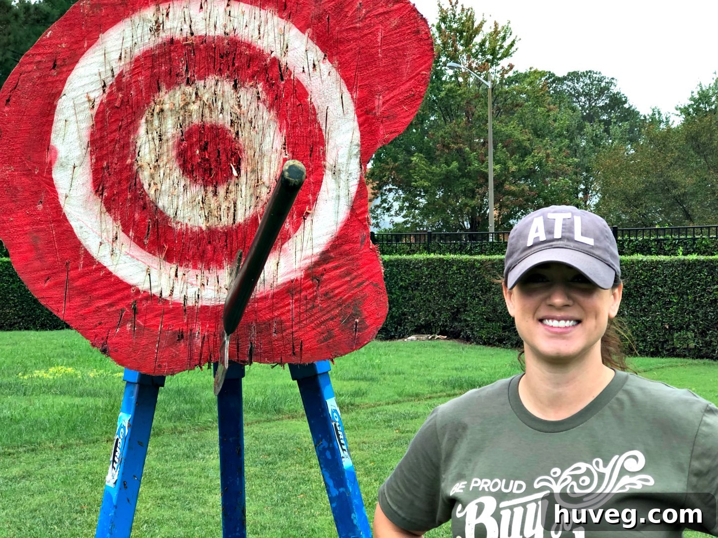 Woman concentrating while throwing an axe at a target