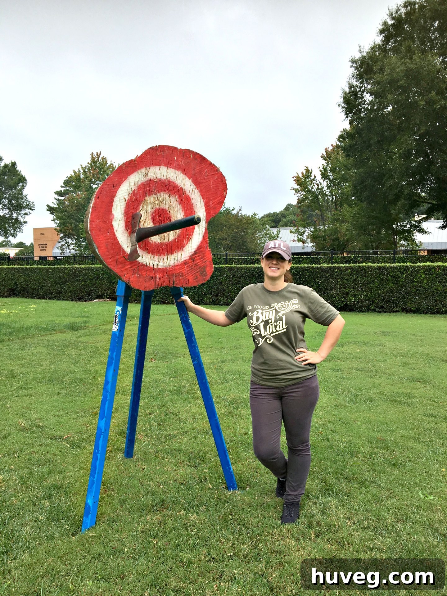 Two women smiling and throwing axes at targets at the STIHL event, having fun