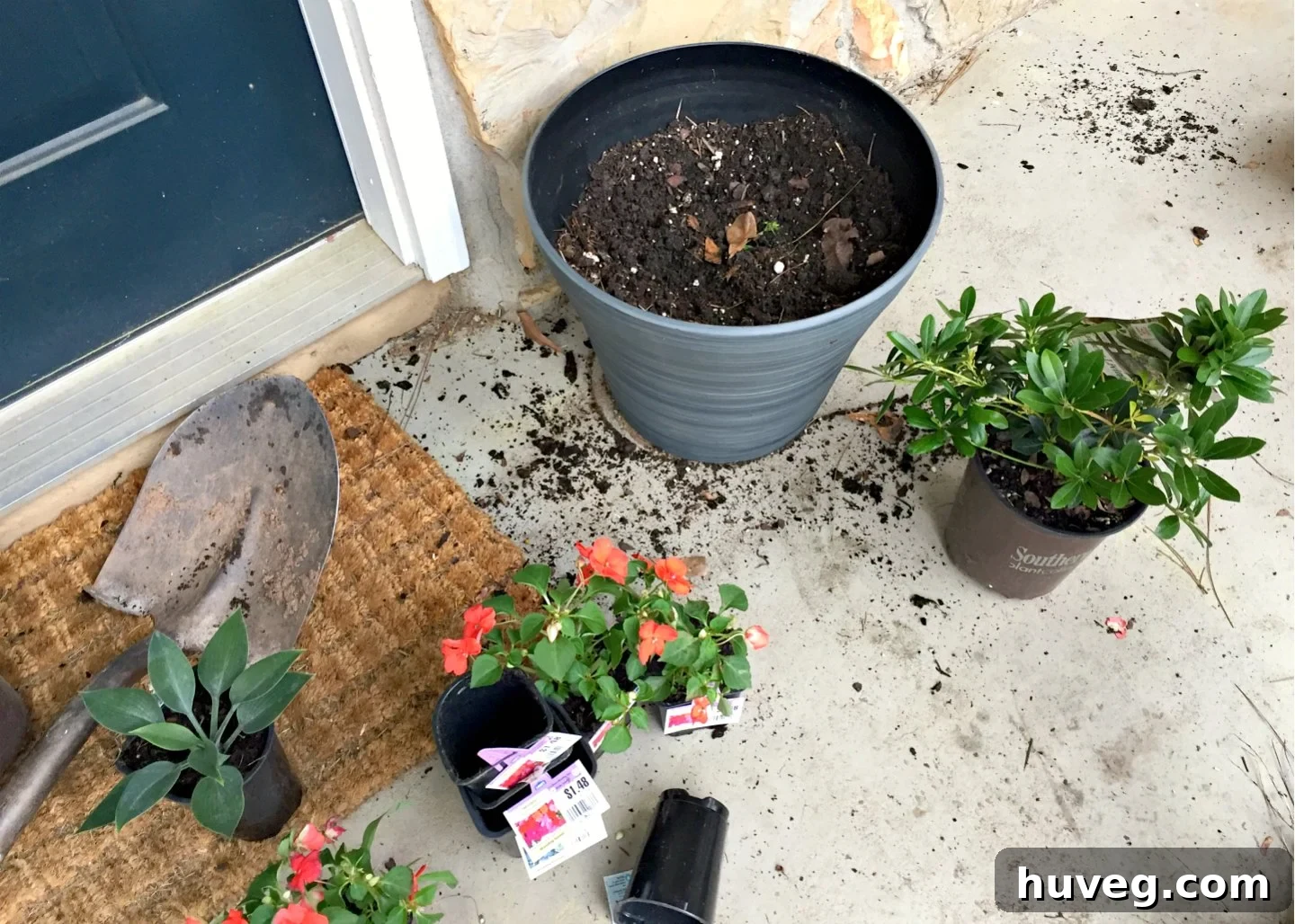Filling a container with plastic bottles, a newspaper layer, and then potting soil for lightweight planting