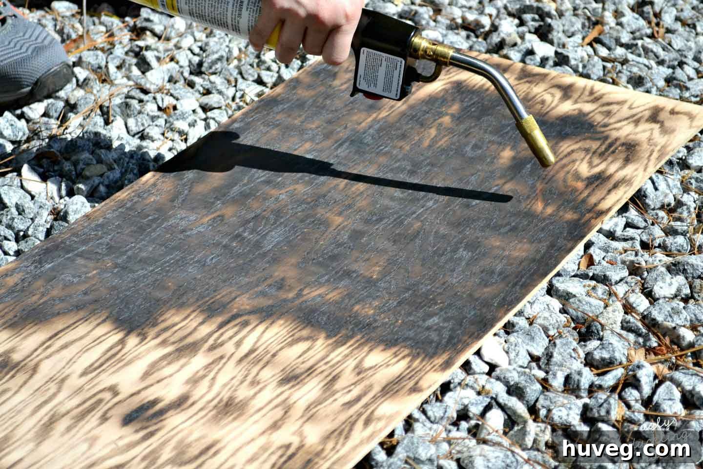 Apply a steady amount of fire to your plywood to create an even char on the wood. 