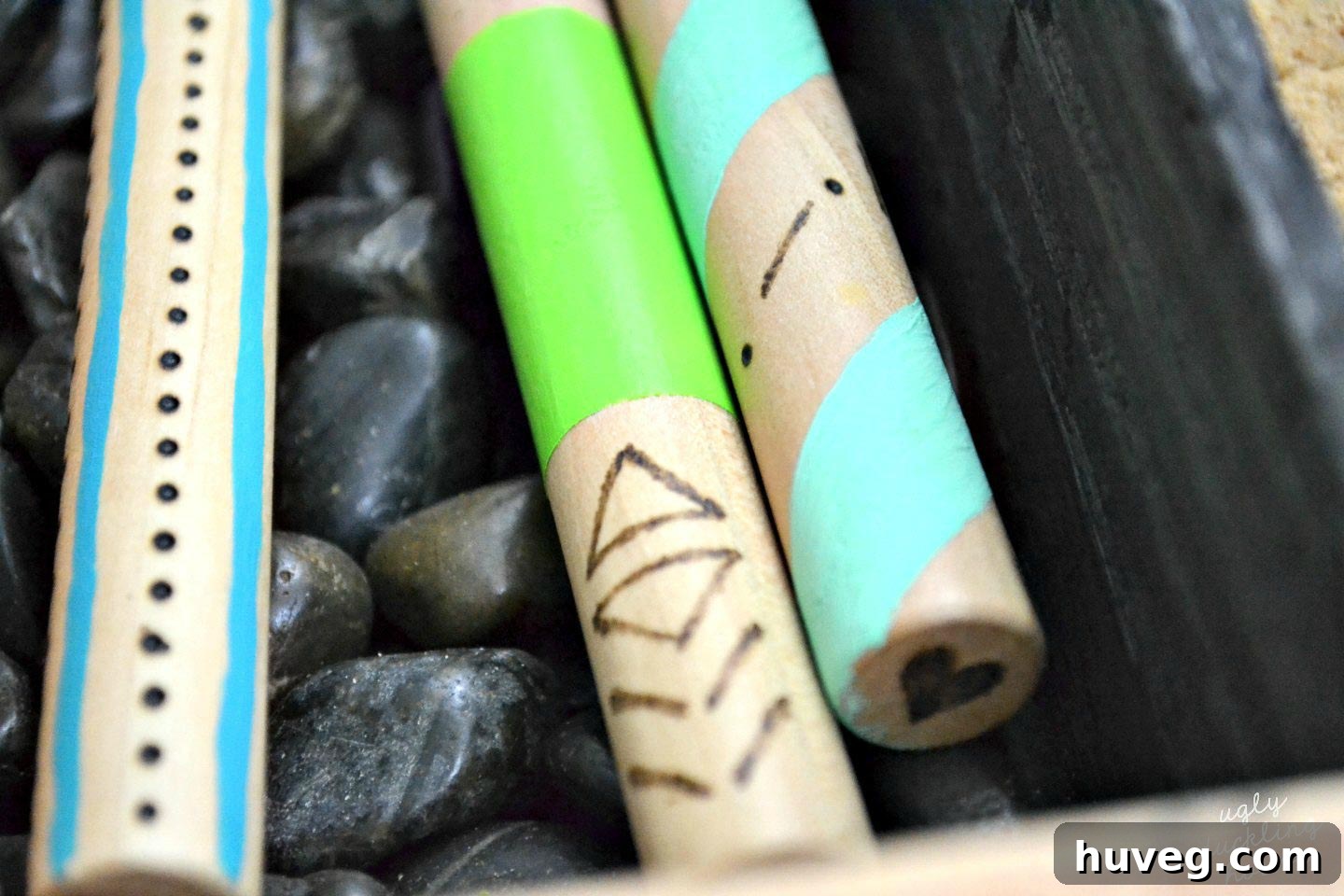 Woodburning detail on the colorful handles of my marshmallow roasting sticks.