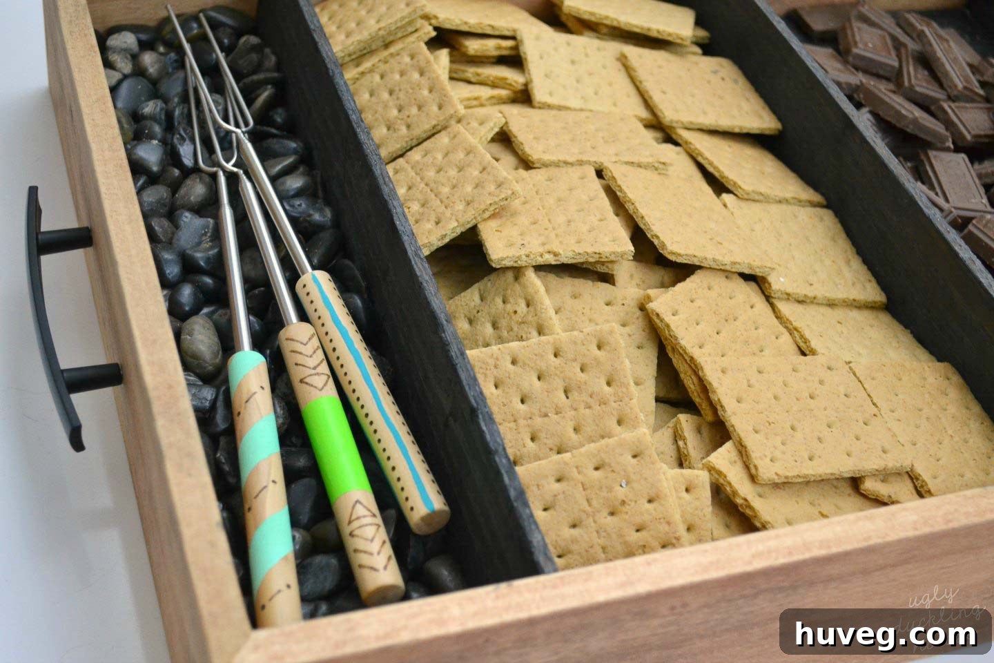 After customization: personalized roasting sticks with unique wood-burned designs and painted handles