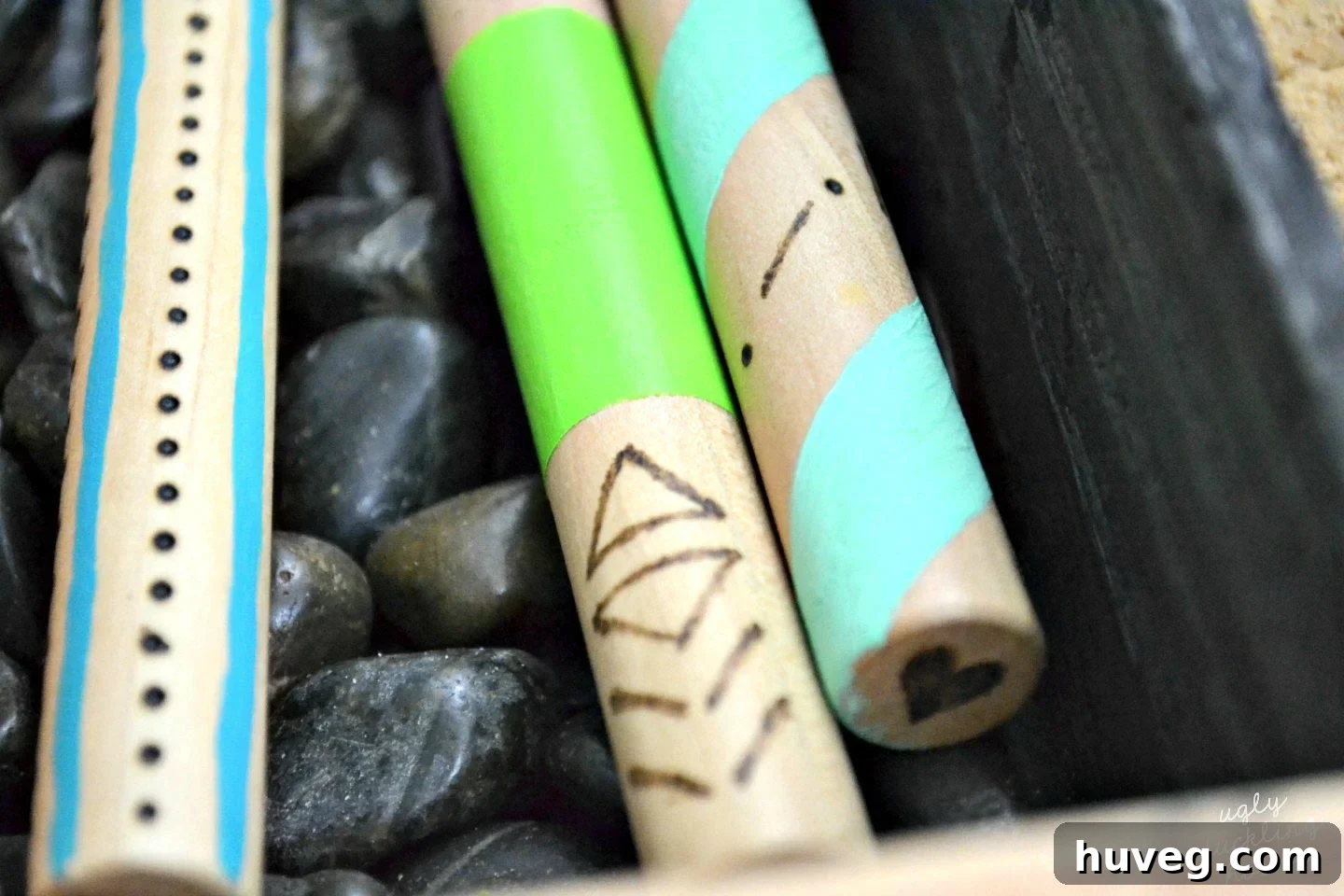 Close-up of customized wood-burned roasting sticks, highlighting personalized designs and painted details