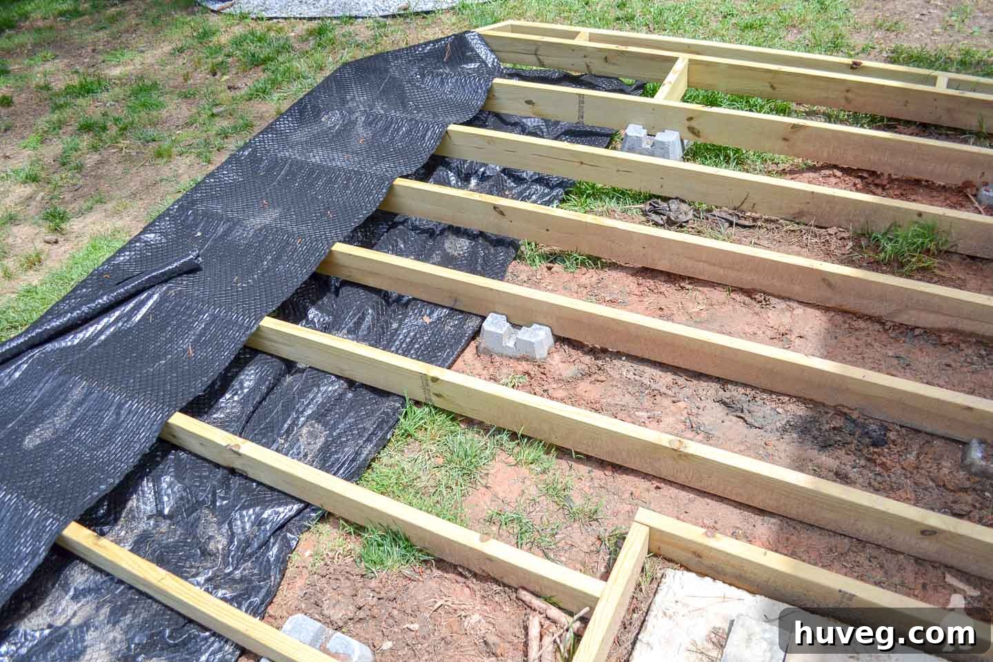 add in landscape fabric under floating deck