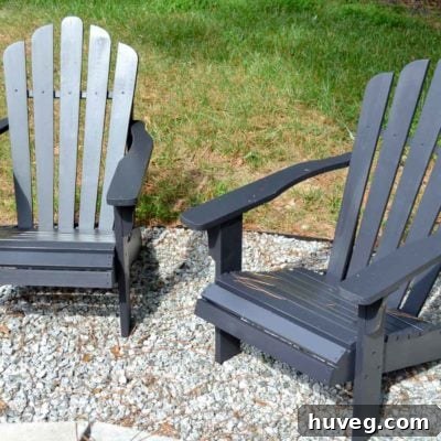 Adirondack chairs painted in a striking Tricorn Black finish, complementing modern outdoor decor and providing comfortable seating