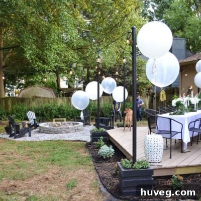 backyard with floating deck fire pit and hanging outdoor lights