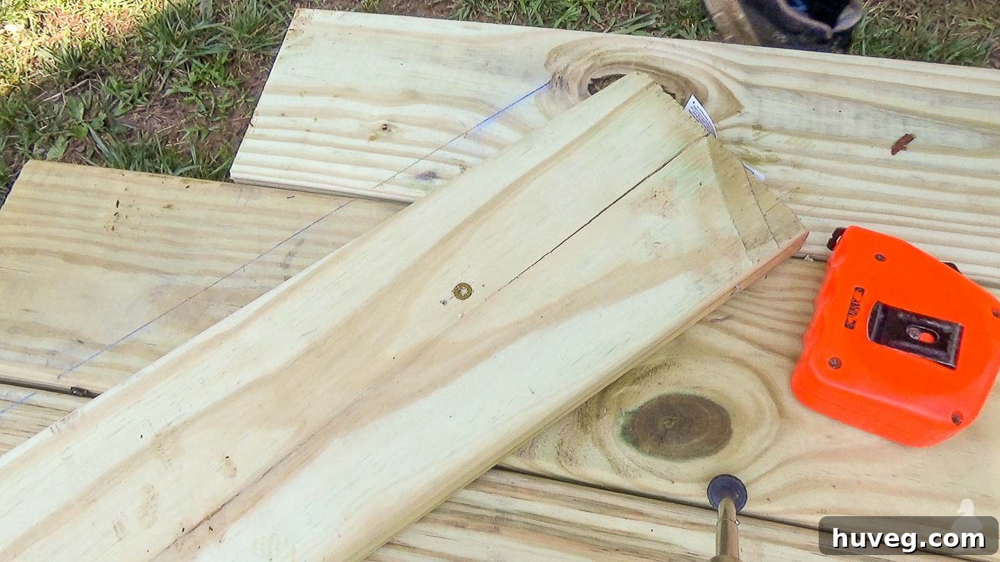 closeup of snapped chalk like with straight board to use as cutting guide on deck trim