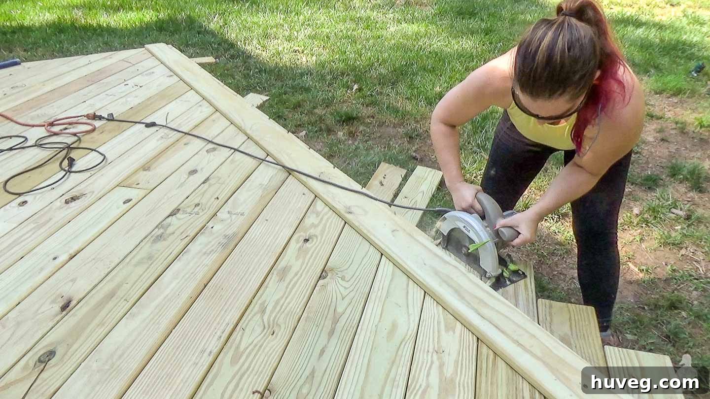 woman (me) trimming off end of deck boards