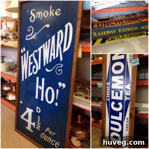 Several large, vintage-style industrial signs, including a prominent blue one priced at $99, displayed at Habitat ReStore.