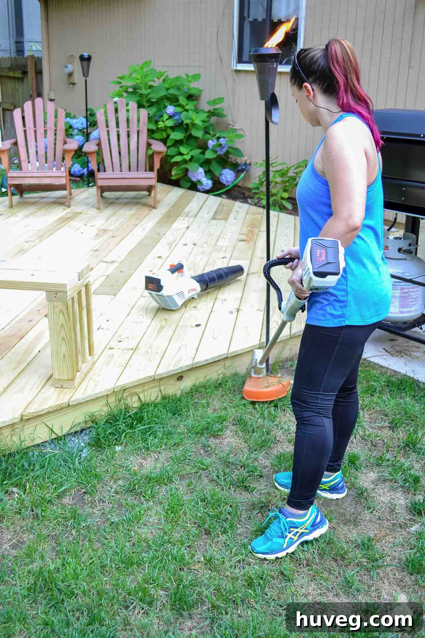 trimming grass around new deck