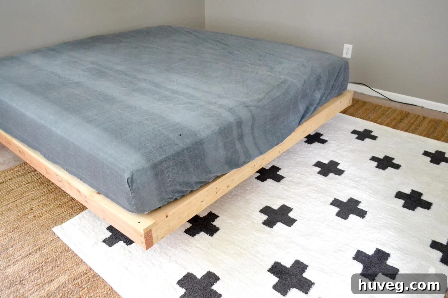 master bedroom with floating bed frame, jute rug, and moroccan shag rug, showing new layout