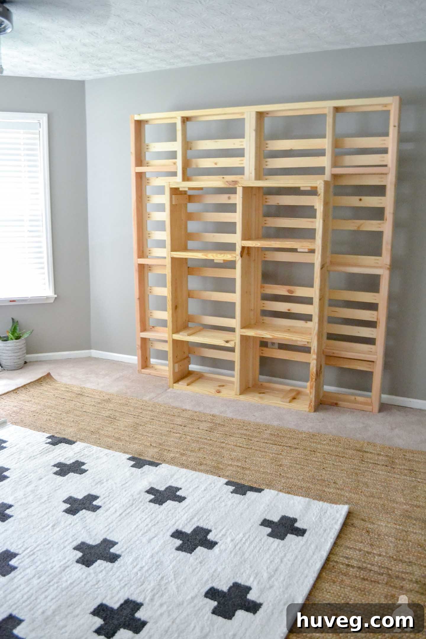 putting new layered rugs down under bed, bedroom renovation process