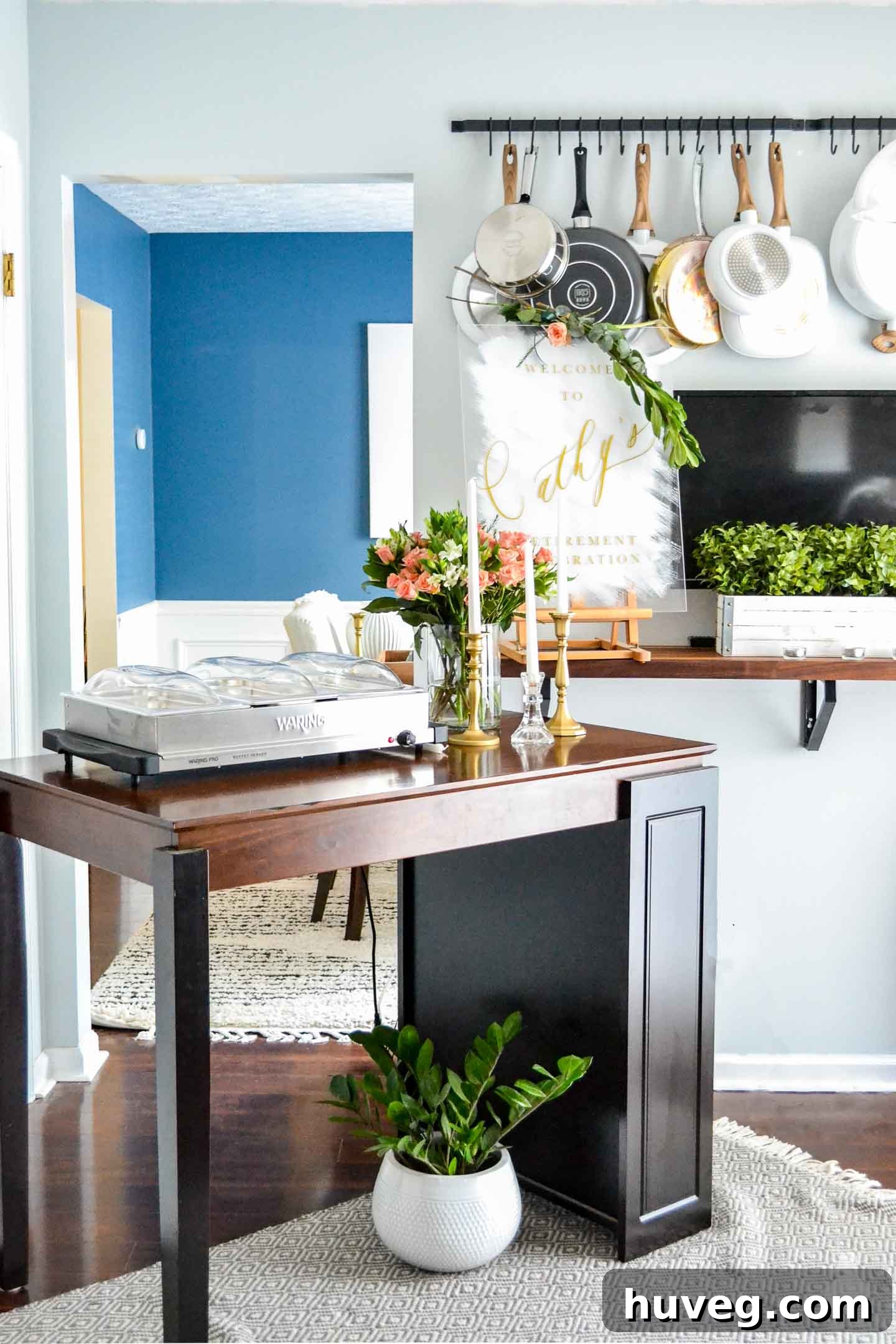 buffet setup on table with blue kitchen walls and dining room
