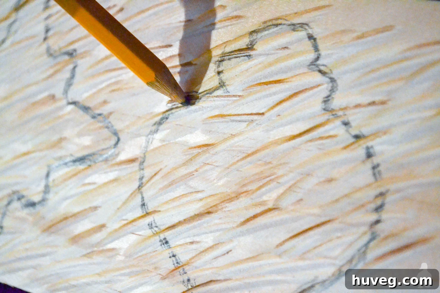 Pencil mark clearly outlining an ornament shape on textured wood, ready for cutting. This showcases the design phase for DIY rustic wood ornaments.