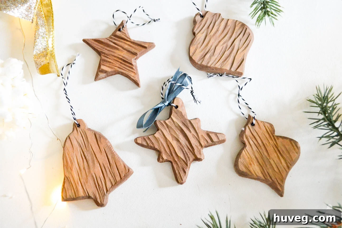 Beautifully crafted DIY rustic carved wood ornaments displayed, showcasing their unique texture and rustic charm, perfect for holiday tree decoration.