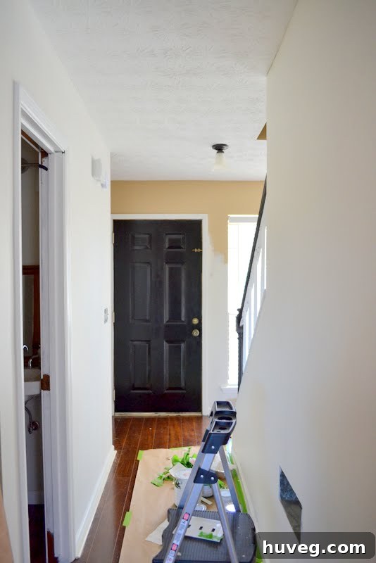 Living room walls prepped for painting, eliminating tan color