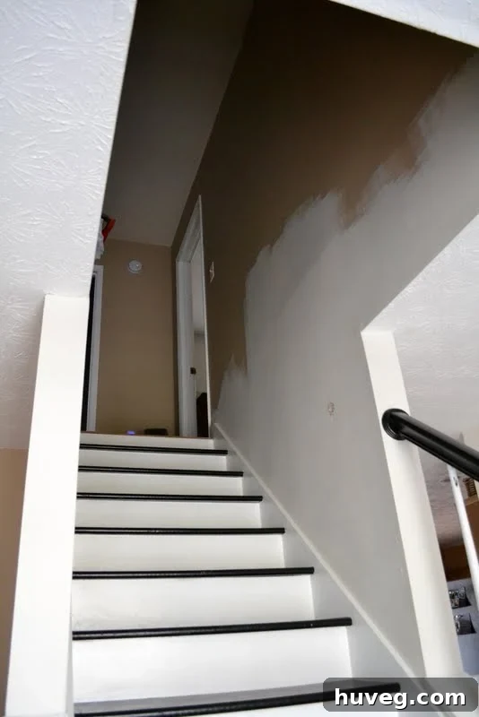 Progress of white paint on staircase walls