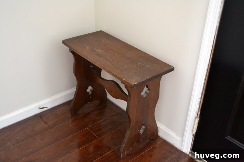 Close-up of vintage wooden bench in a freshly painted greige entryway