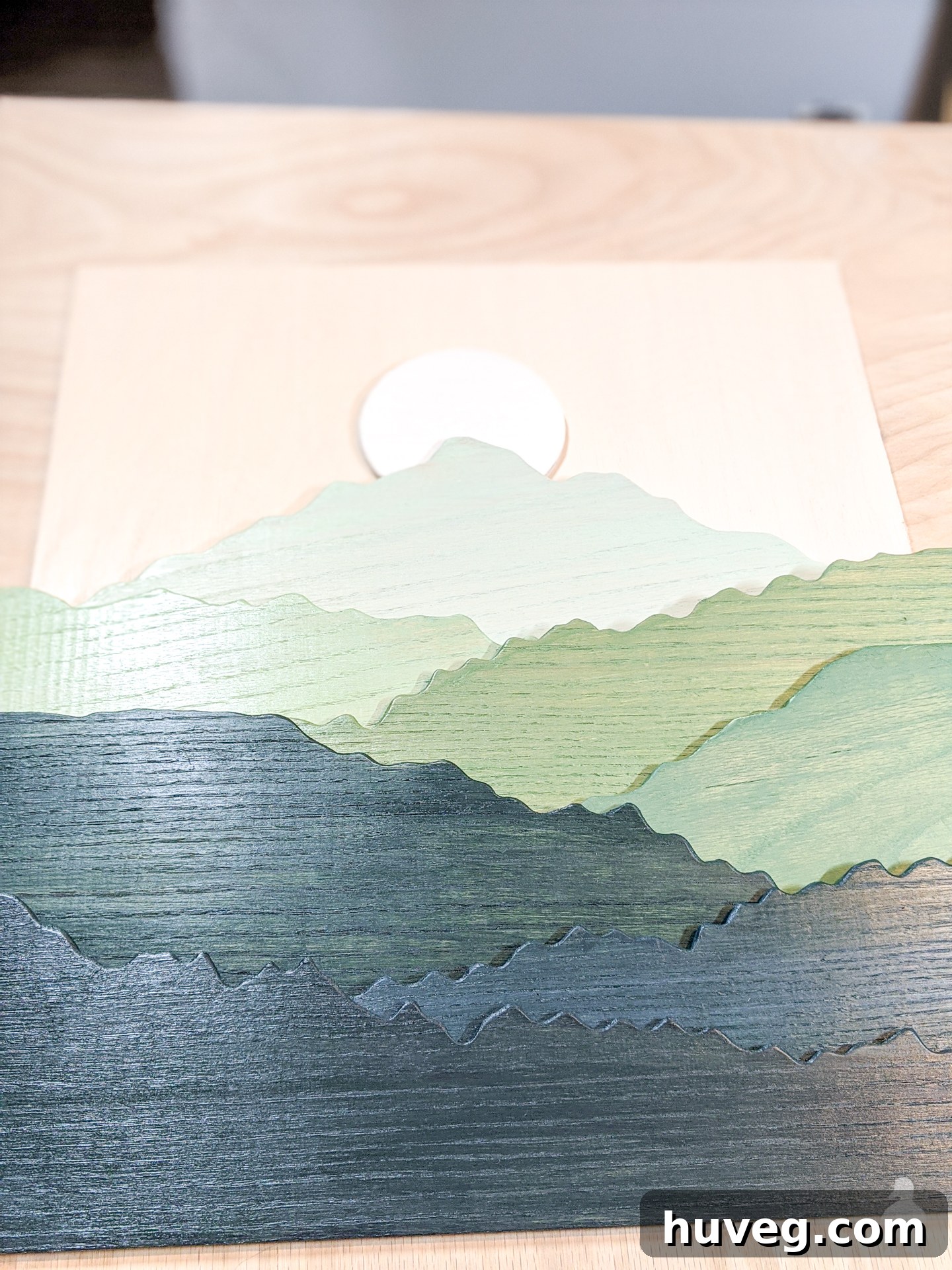glue and nail each piece of stained wood to the backing for layered art