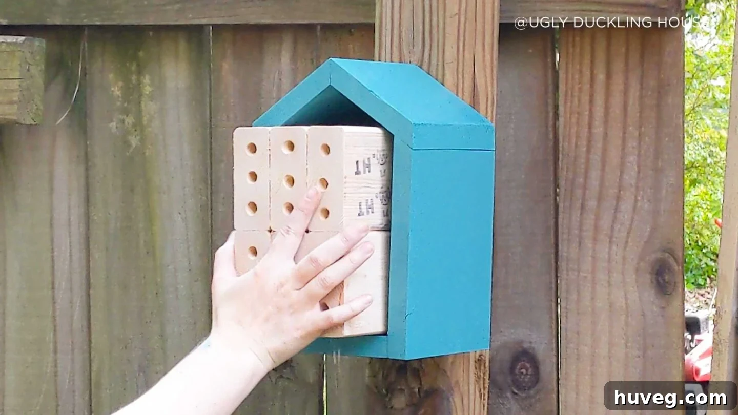 inserting bee nesting wood
