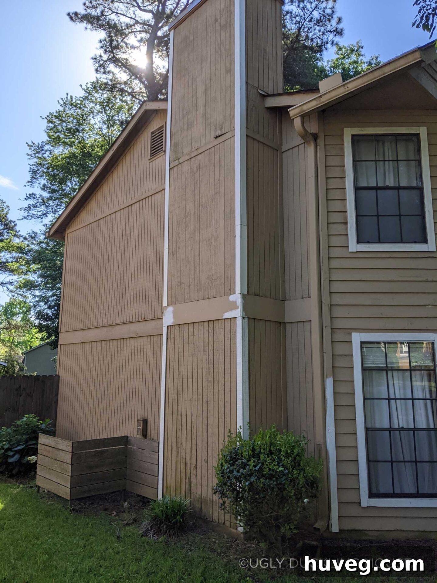Unfinished trim work on the side of a house, showcasing the neglected exterior before the full repaint