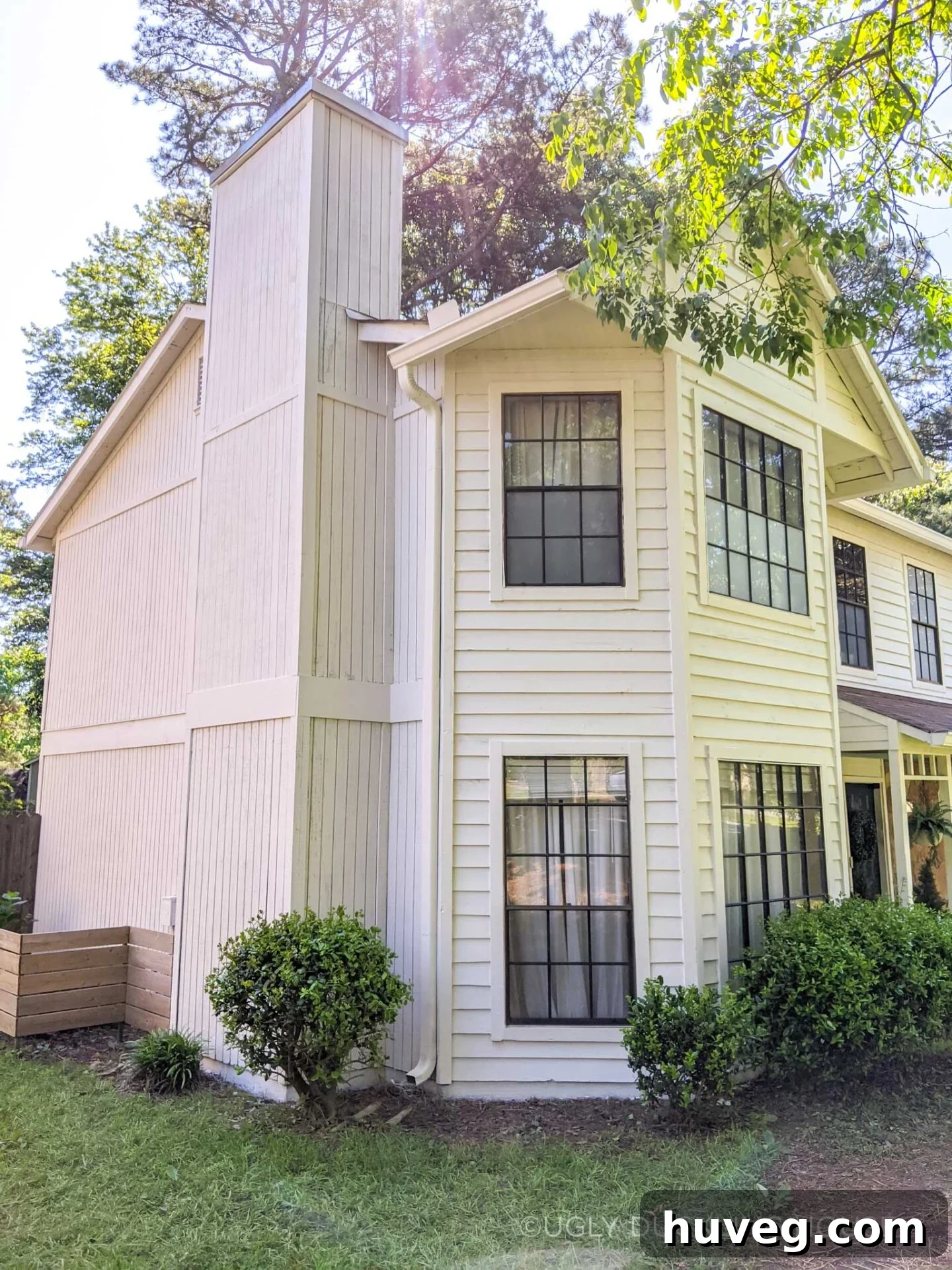 Side view of the house after its new white paint, showing a clean, cohesive exterior