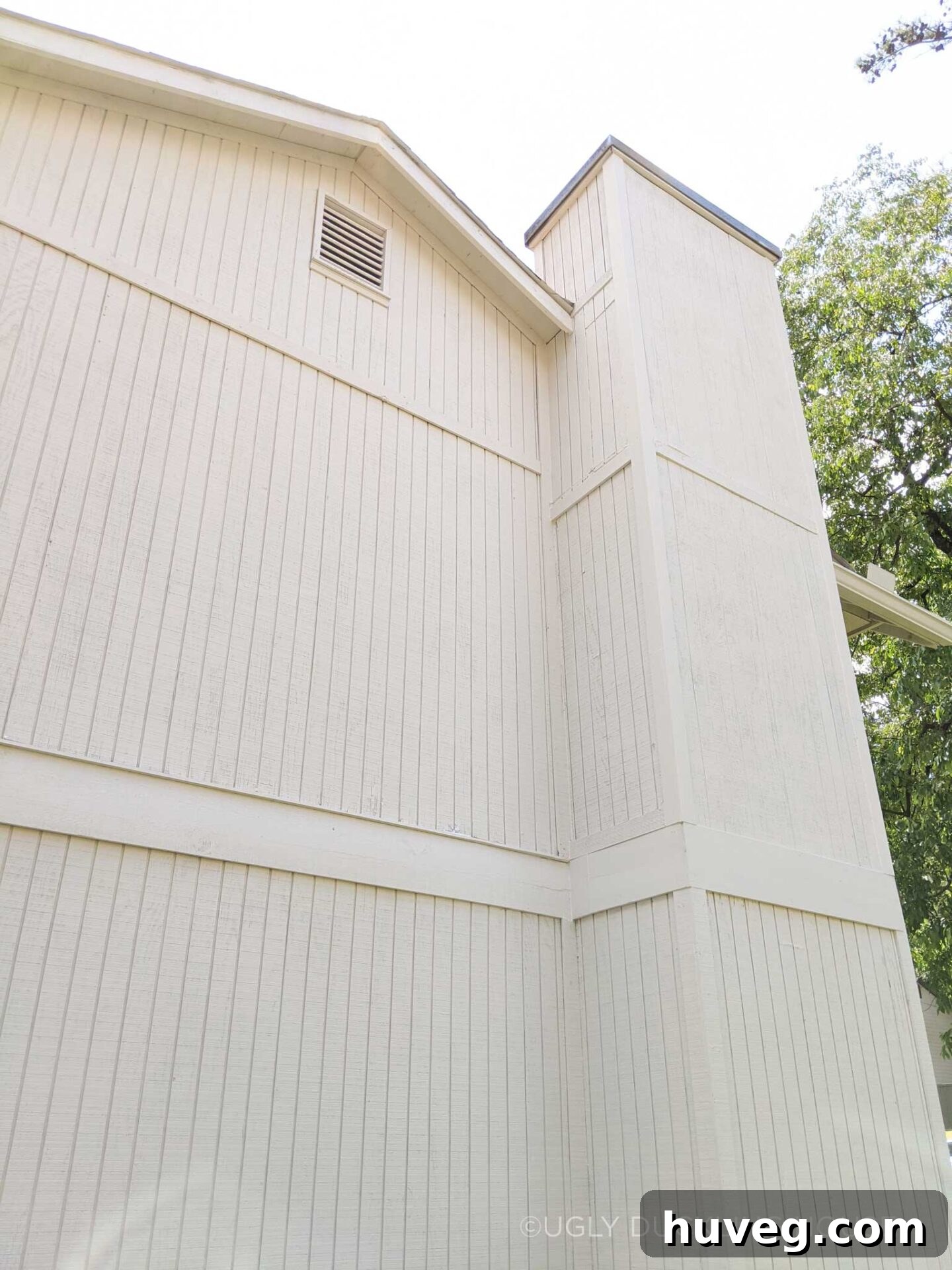 Close-up of house siding after new Sherwin-Williams Shoji White paint, showing the natural texture of the cedar