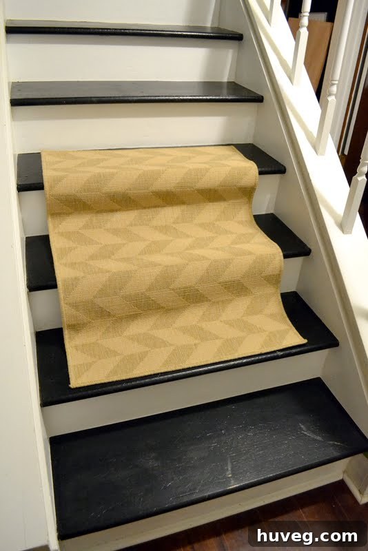 Close-up of a black painted stair showing visible scratches and gouges, a common issue in pet-friendly homes.