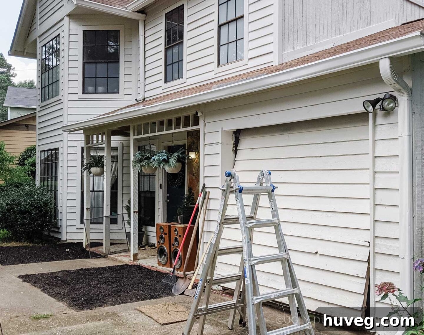 before - white siding on garage door