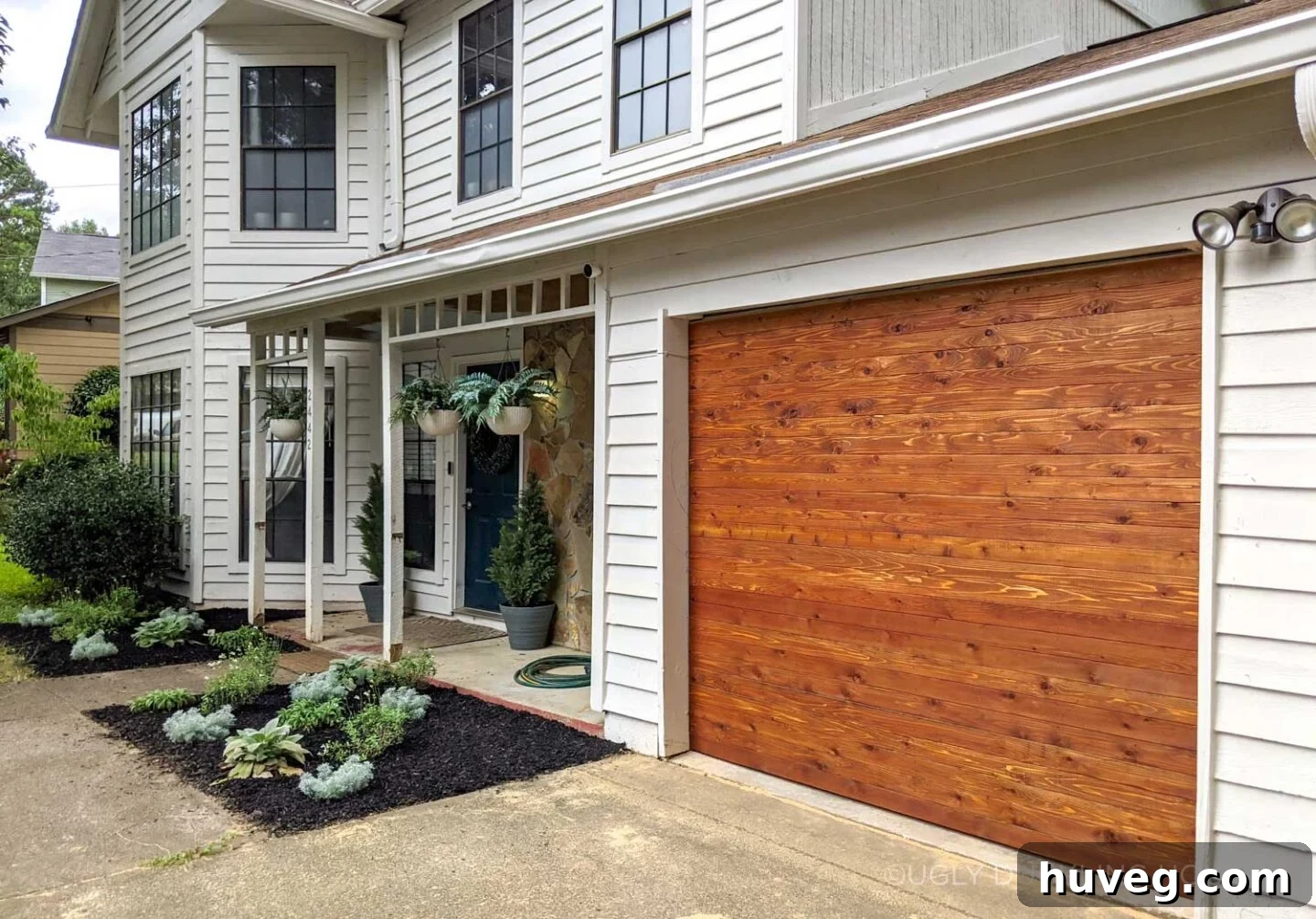 after - new cedar garage door and white siding