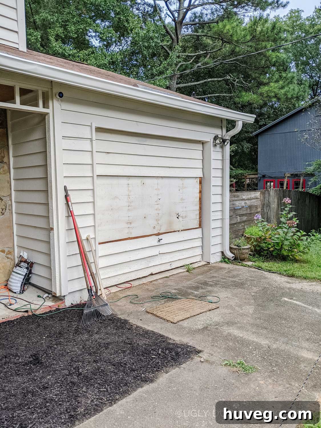 removing the old siding from the garage door
